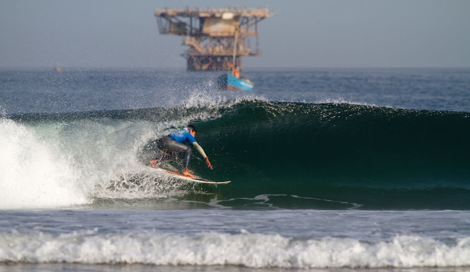 Oil drilling was established in Lobitos, Peru in the early 1900s and continues today, lining the pockets of rich foreign investors and giving back virtually nothing to the community. Featured here is 17-year-old local Lobitos surf talent, Henry Espinoza. Photo: Brody/<a href=\"https://www.surfresource.org/\" target=_blank>SurfResource.org</a>